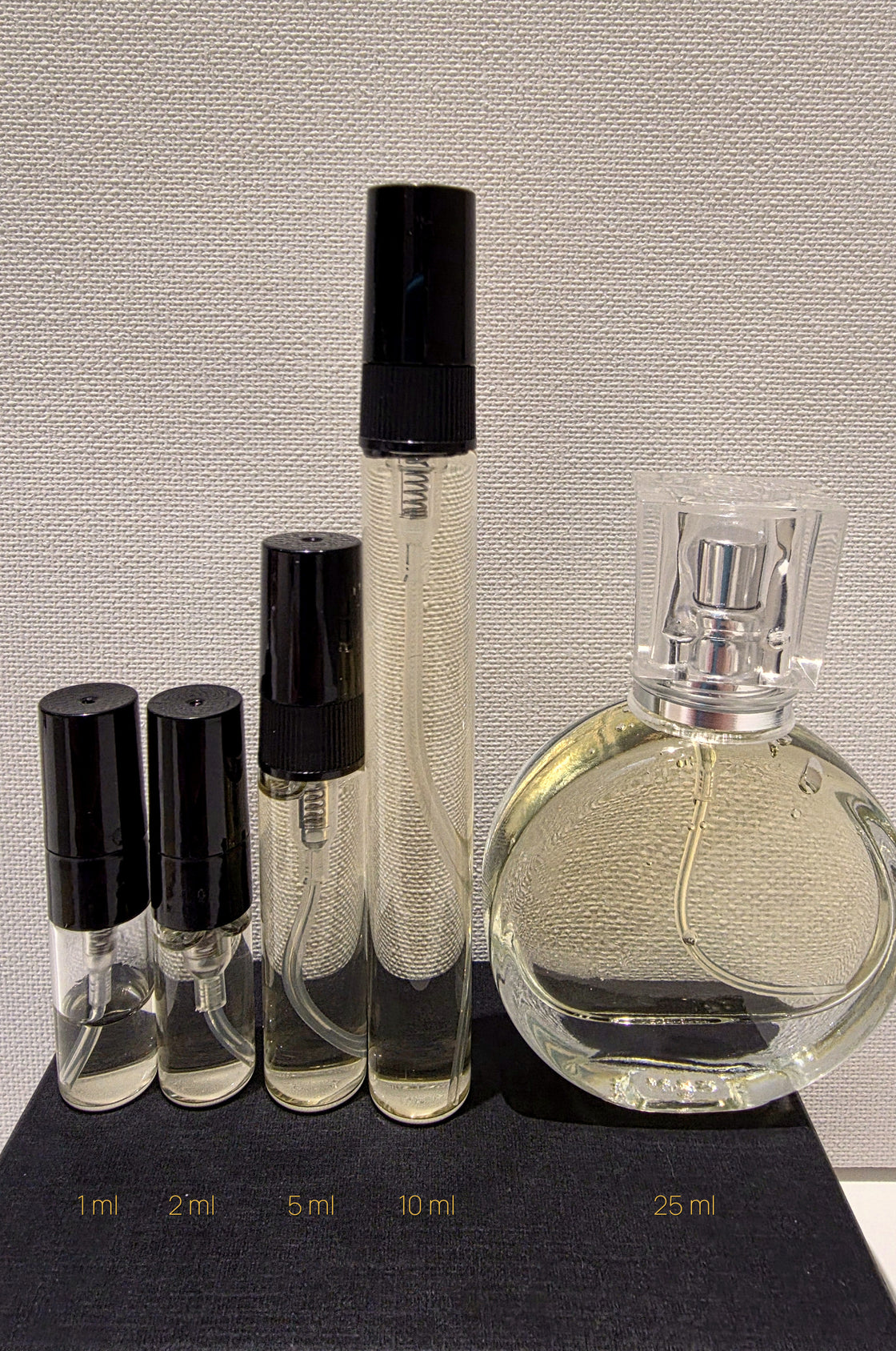 The five Gilded Senses decant sizes side by side, filled, showing true relative scale.